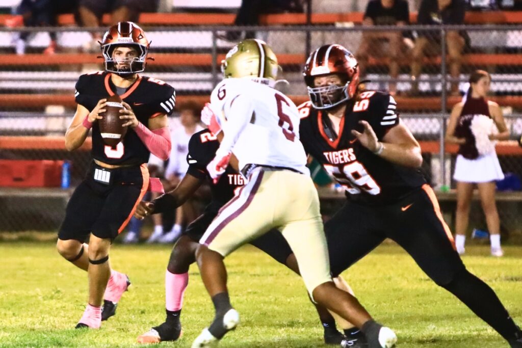 Trenton quarterback Jackson Gentry (5) looks downfield to pass against Oak Hall. Photo by C.J. Gish