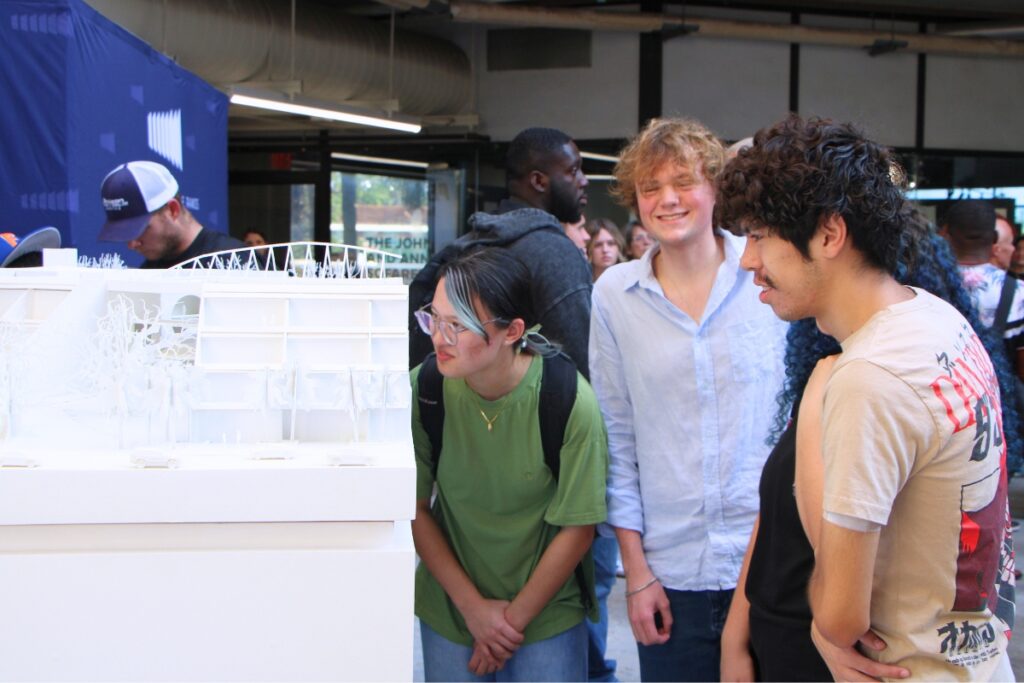 UF students examine a model of the Ramos Collaboratory during a ribbon cutting ceremony. Photo by Lillian Hamman
