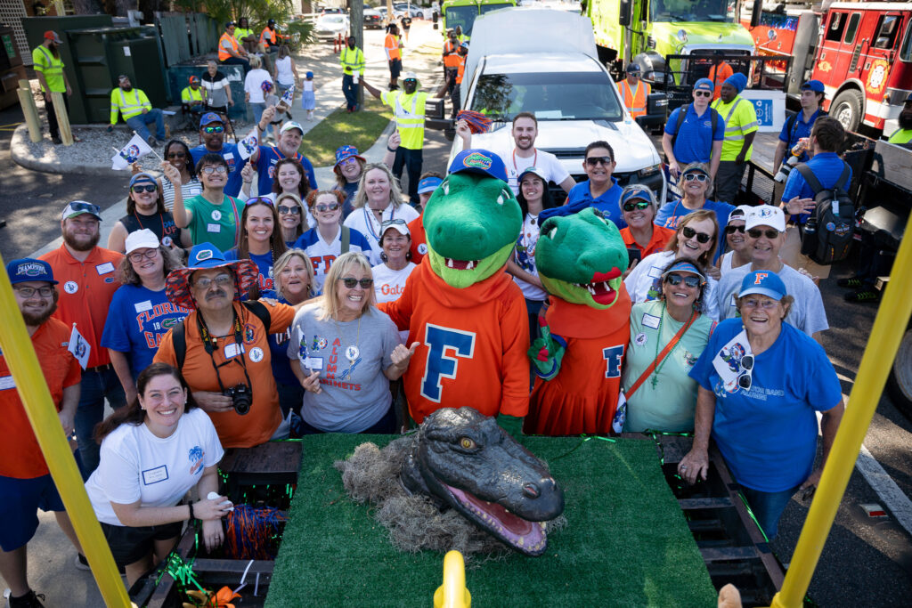 UF's Albert and Alberta, standing with Gator Band Alumni behind the 1978-1983 _Creepy Gator_ mascot head
