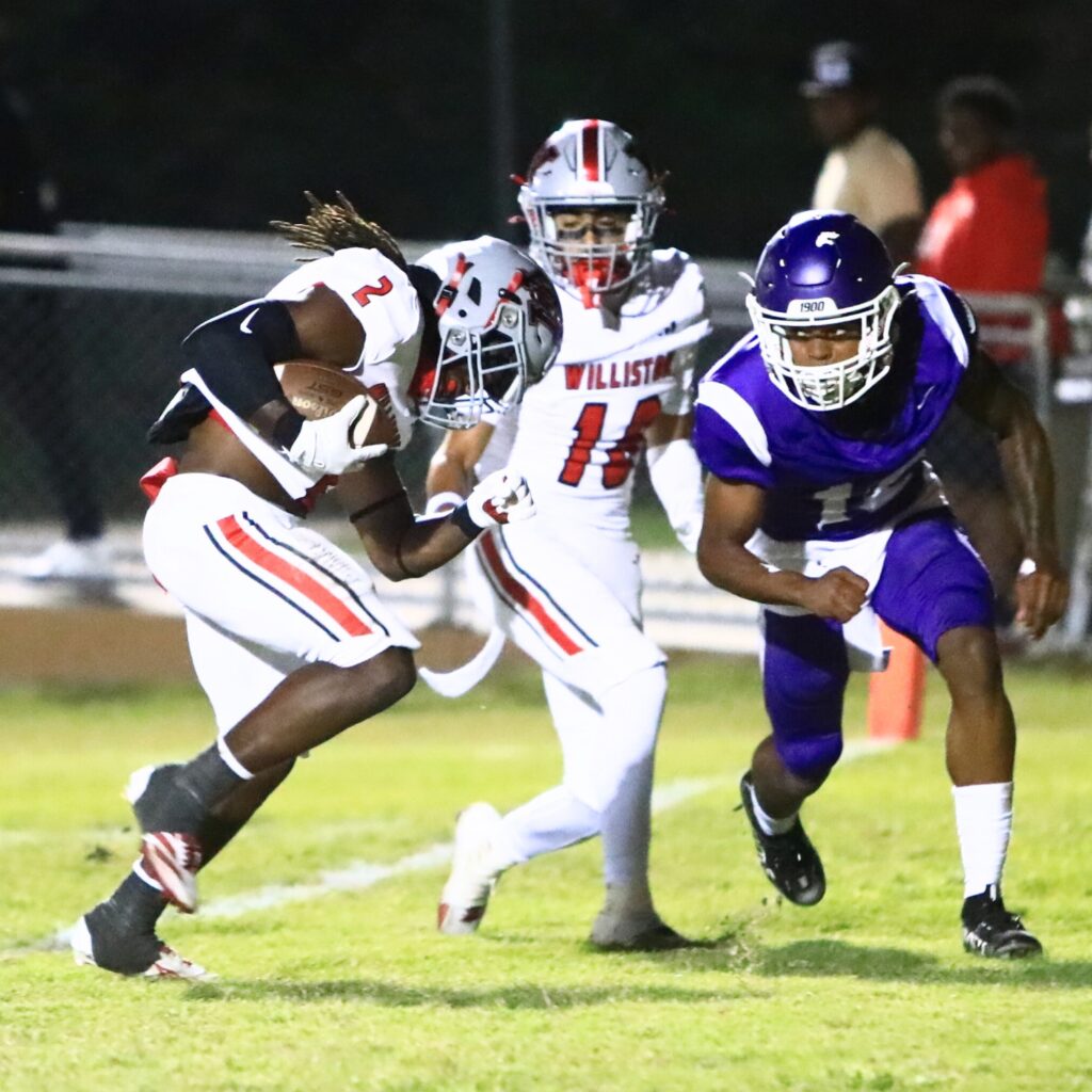 Williston J'Dyen Manneh (2) gets past Gainesville's Joshua McCellan (12) for a second-quarter touchdown. Photo by C.J. Gish