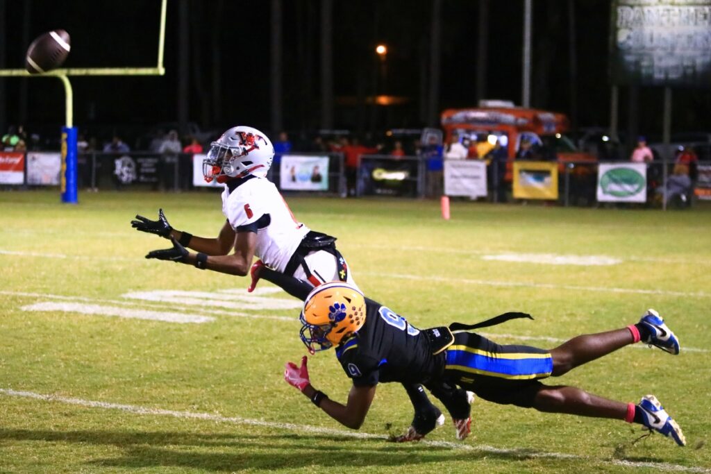 Williston's Marcus Appling (6) intercepts a fourth-quarter pass intended for Newberry's Javeon Long (9). Photo by C.J. Gish