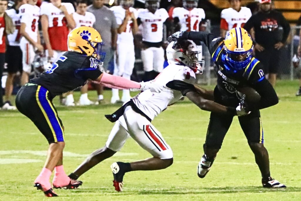 Williston's Maverick Jones (8) tackles Newberry's Zaden Wilcox (0). Photo by C.J. Gish