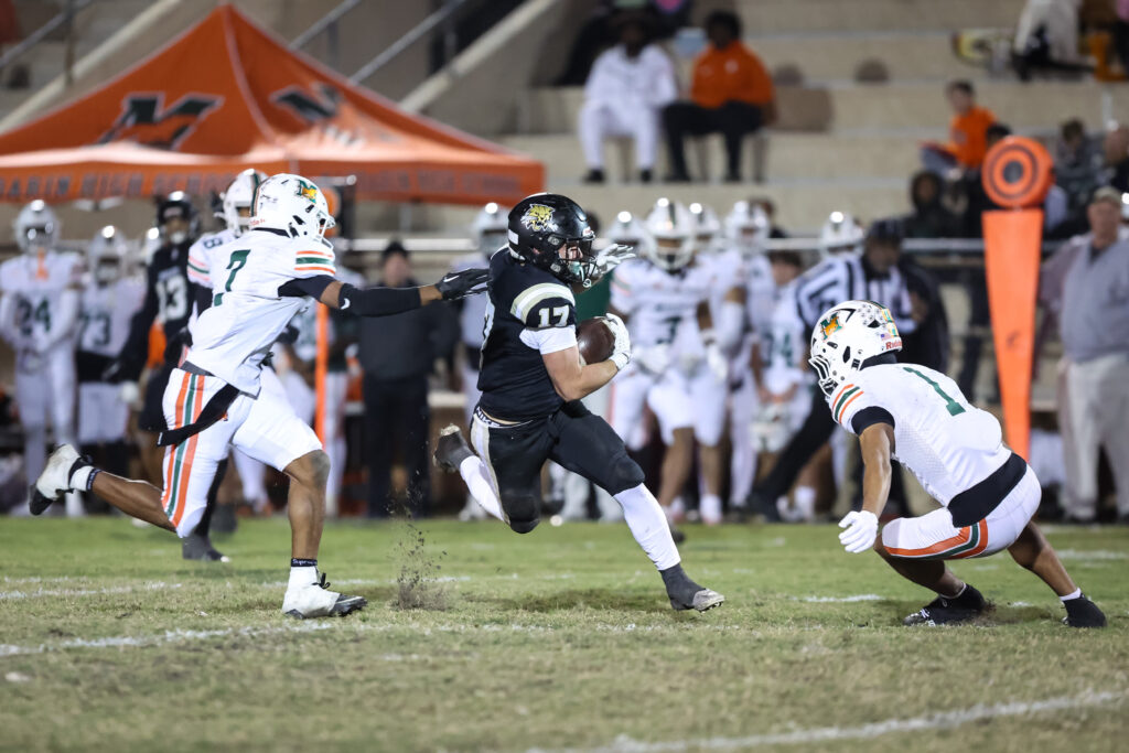 Buchholz player Ashton Norris (17) runs with the ball during the second half the regional final between Mandarin and Buchholz Friday at Citizens Field.