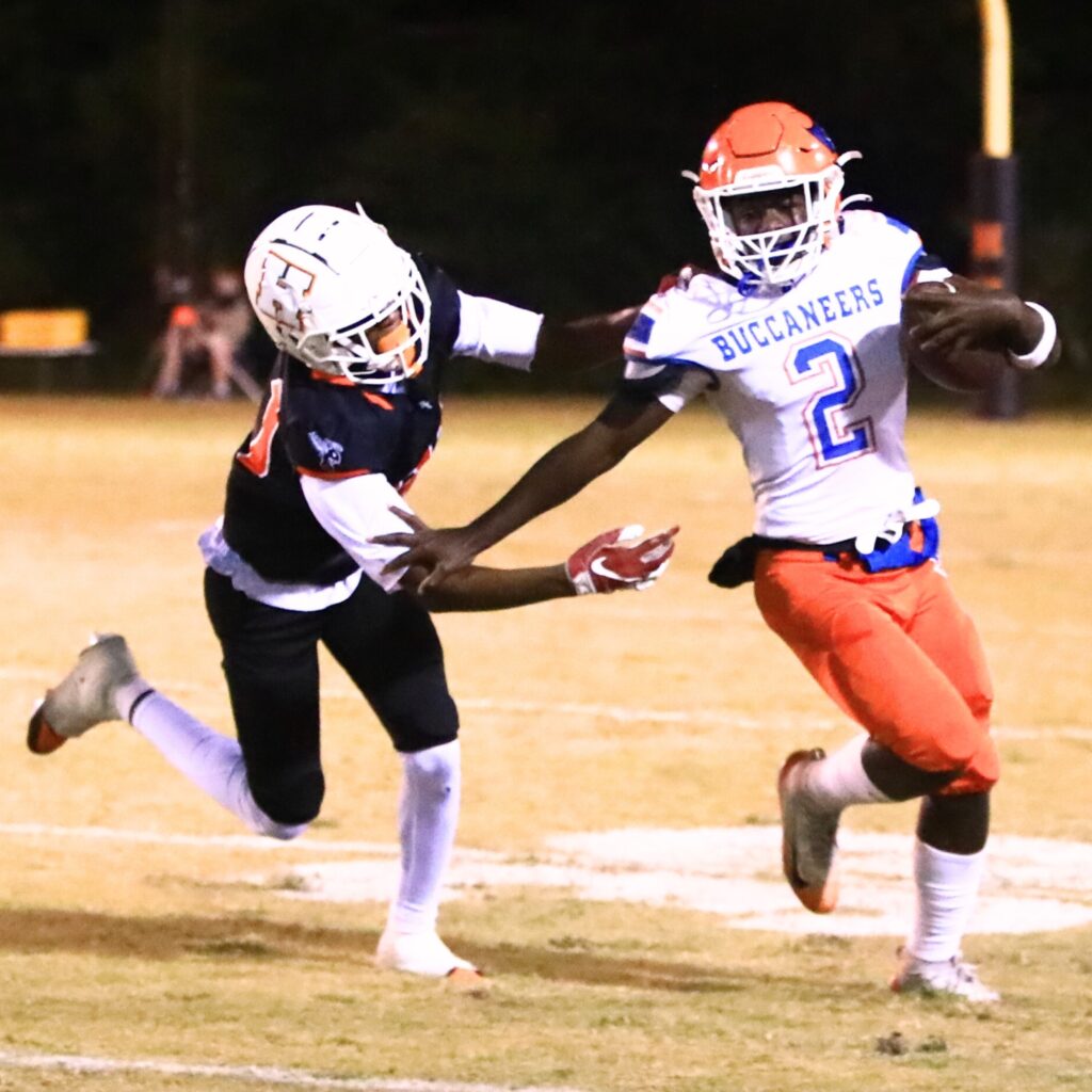 Branford's Ollie James (2) tries to evade Hawthorne's Kevin Golden (31) in the Rural Regional Semifinals. Photo by C.J. Gish