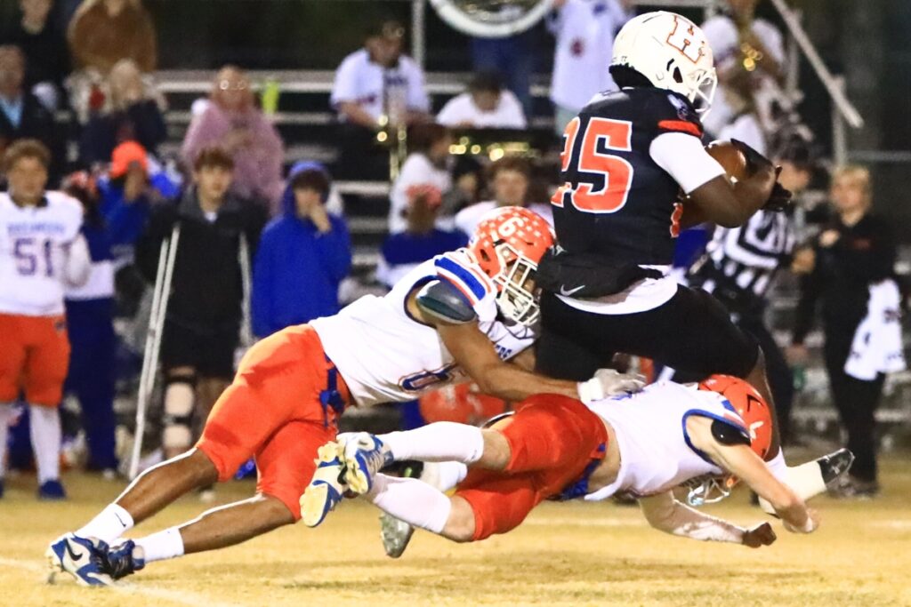 Branford's TC Smith (6) and Tripp Schultz (8) bring down Hawthorne's Derryek Gillins (25) in the Rural Regional Semifinals. Photo by C.J. Gish