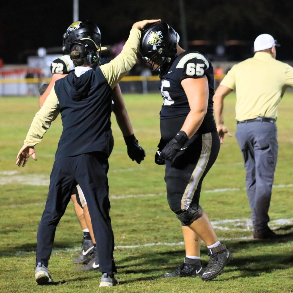 Buchholz head coach Mark Whittemore celebrates with players after a field goal gave the Bobcats a 17-7 lead heading into halftimeagainst Nease (Ponte Vedra) in the Class 6A-Region 1 Semifinals. Photo by Seth Johnson