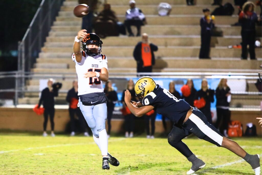 Buchholz's Amir Sheppard (0) with a quarterback pressure against Oviedo in the Region 1-6A Quarterfinals. Photo by C.J. Gish