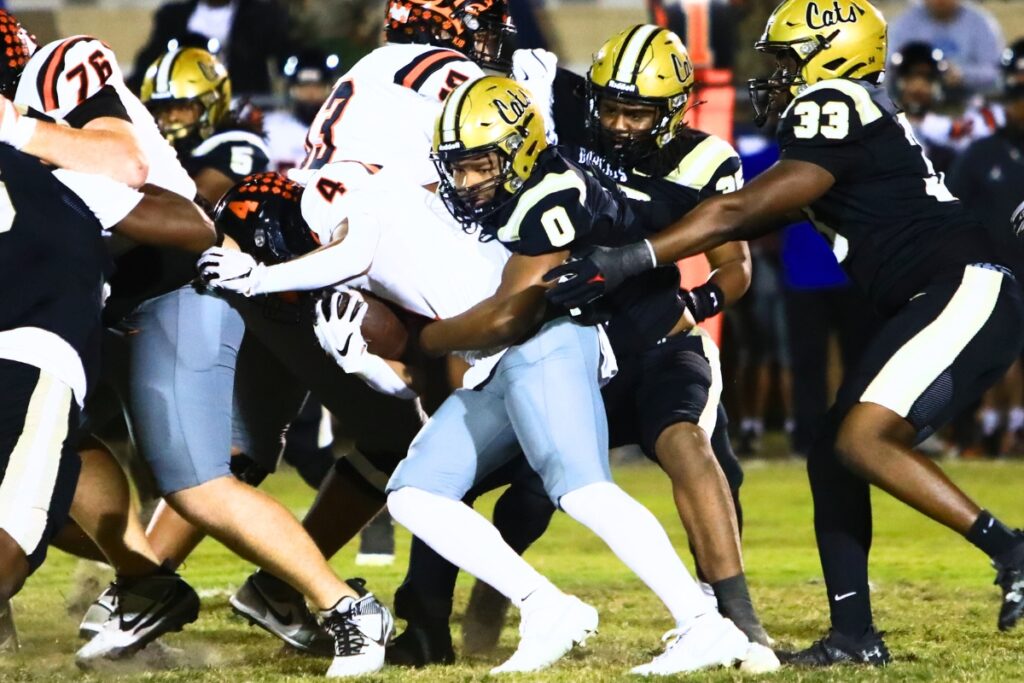 Buchholz's Amir Sheppard (0) with a tackle against Oviedo in the Region 1-6A Quarterfinals. Photo by C.J. Gish