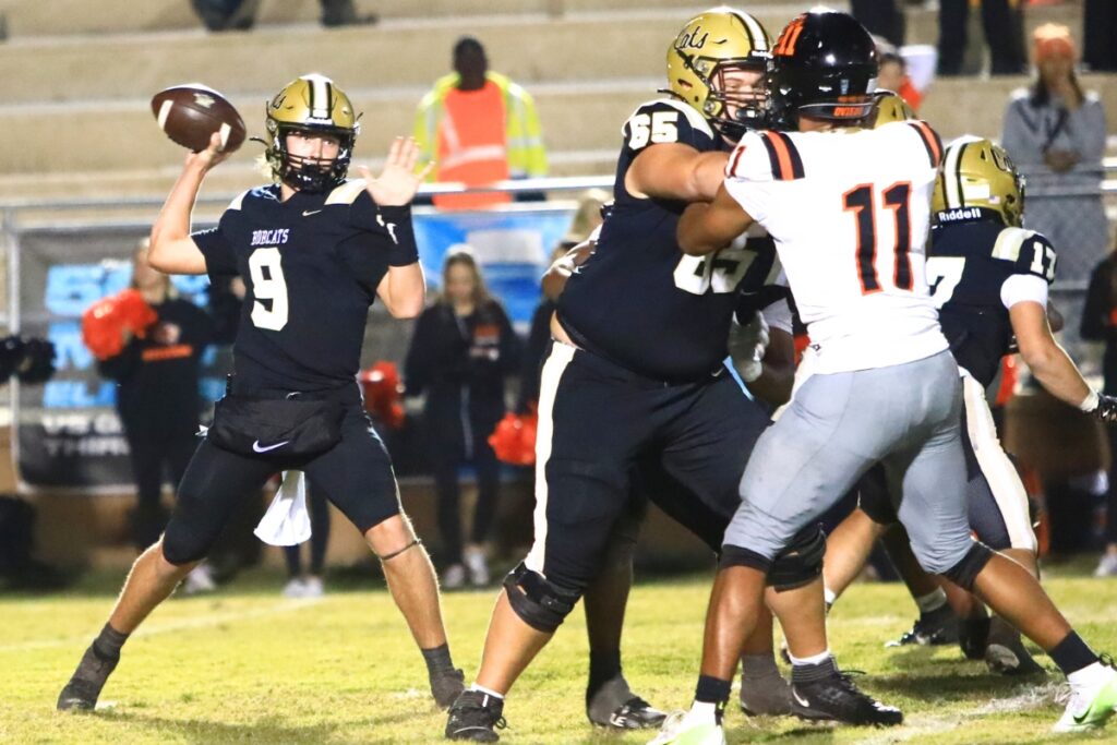 Buchholz's Andrew Whittemore (9) looks to pass against Oviedo in the Region 1-6A Quarterfinals. Photo by C.J. Gish