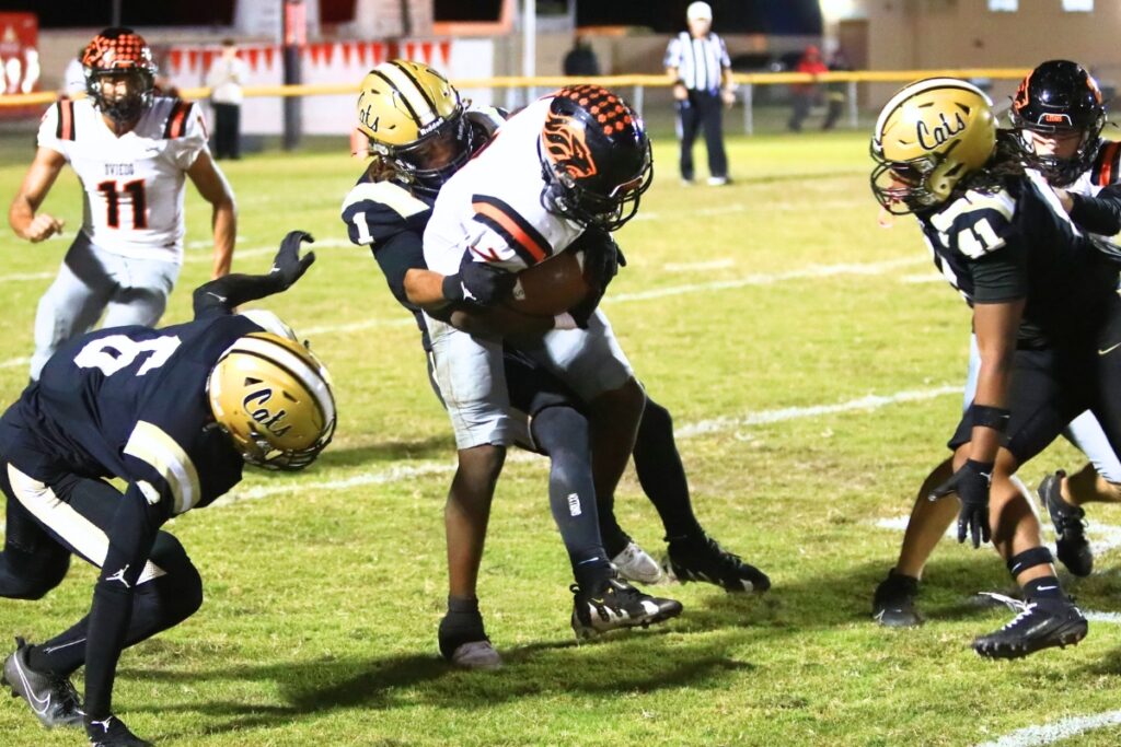 Buchholz's Chris Johnson (1) with a tackle on a kickoff against Oviedo in the Region 1-6A Quarterfinals. Photo by C.J. Gish