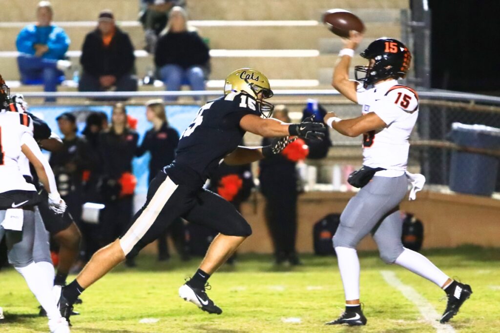 Buchholz's Evan Walker (15) pressures the quarterback against Oviedo in the Region 1-6A Quarterfinals. Photo by C.J. Gish
