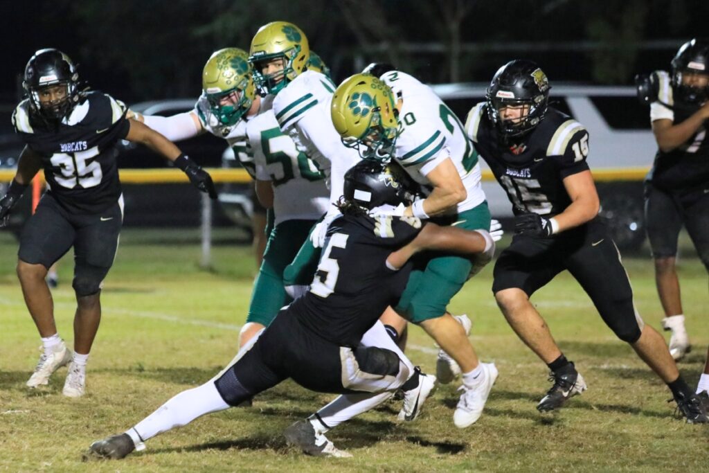 Caleb Young Jr. (5) stops a Nease (Ponte Vedra) runner in the Class 6A-Region 1 Semifinals. Photo by Seth Johnson