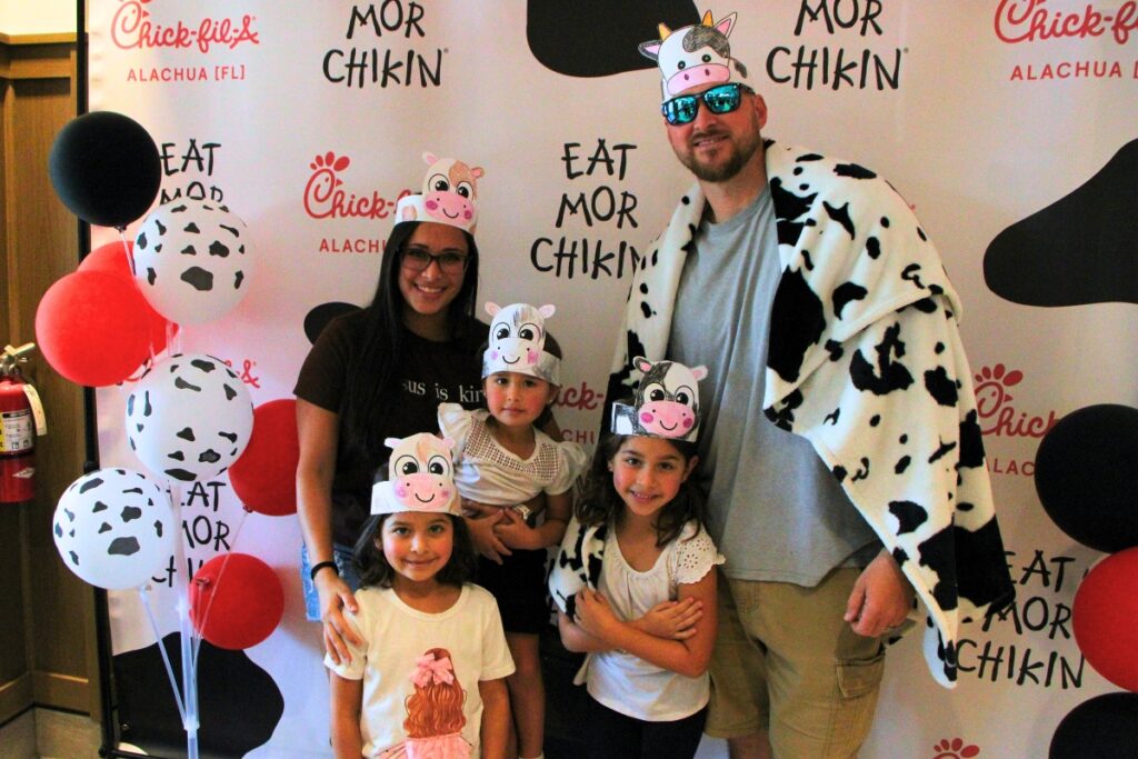 Customers dress as cows to receive free meals on Chick-fil-A's opening day in Alachua. Photo by Lillian Hamman