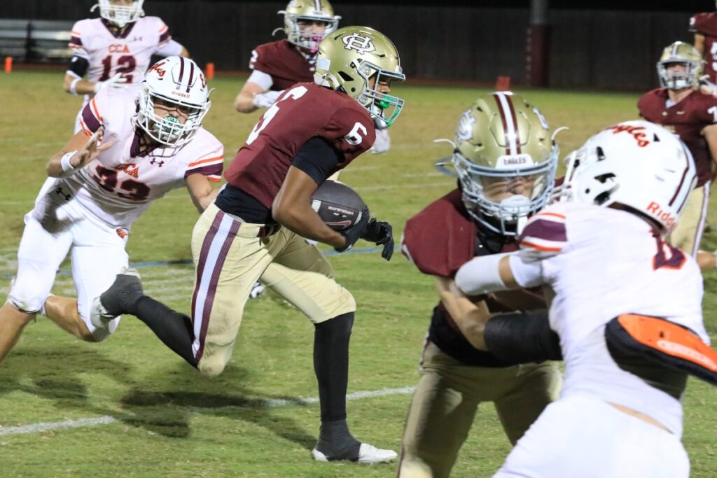 Danny Acs runs for the Eagles against Christ's Church Academy (Jacksonville). Photo by Seth Johnson