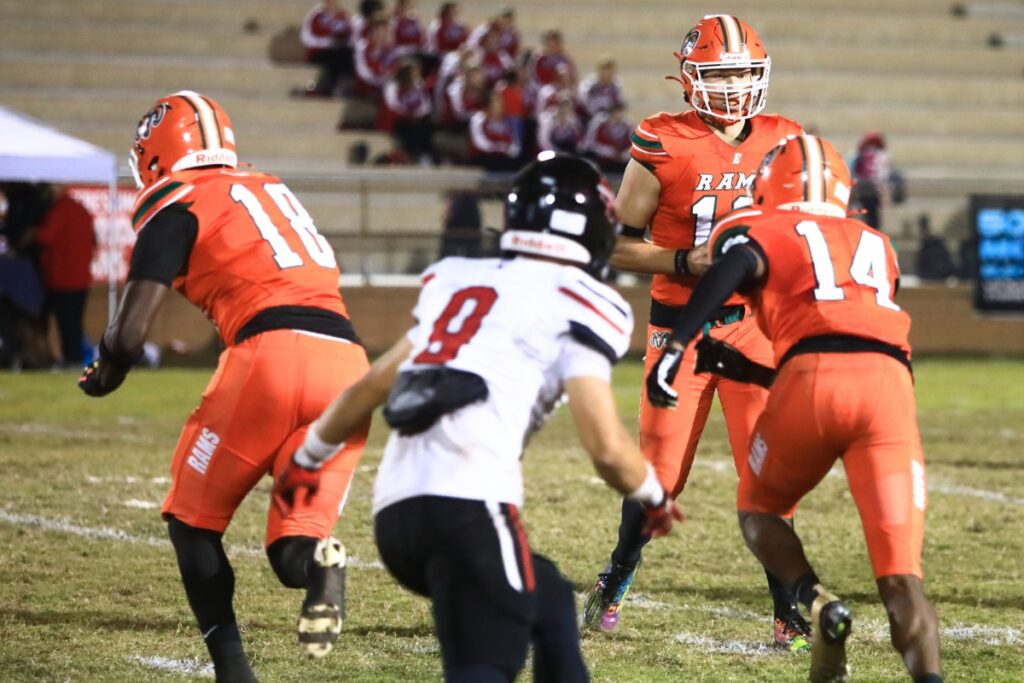 Eastside's Nelson Tambling (13) hands the ball off to Kaleb Mckinnon (14) in the third quarter against South Sumter in the Region 2-3A Quarterfinals. Photo by C.J. Gish
