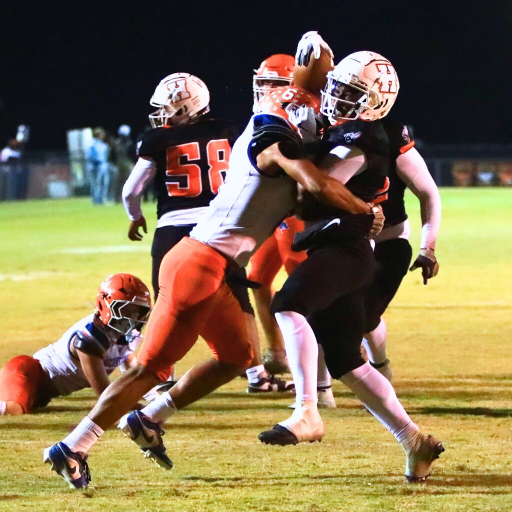 Hawthorne's Darian Bowie (1) powers his was to the 1-yard line with Branford's TC Smith (6) making a tackle in the Rural Regional Semifinals. Photo by C.J. Gish