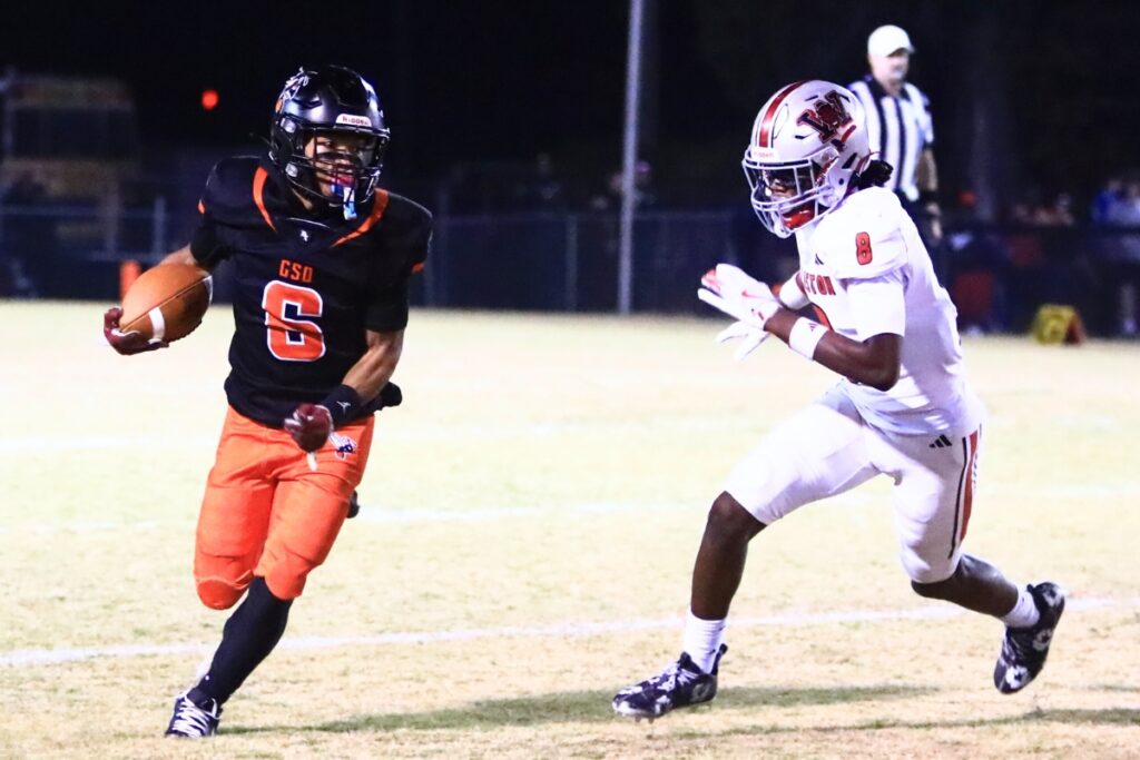 Hawthorne's Raheem Moore (6) tries to get past Williston's Maverick Jones (8) on a punt return in the Rural-Region 4 Final. Photo by C.J. Gish