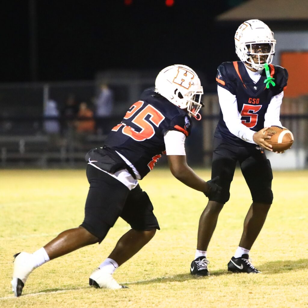 Hawthorne's Richard Roundtree Jr. (5) with a first-quarter handoff Derryek Gillins (25) against Branford in the Rural Regional Semifinals. Photo by C.J. Gish