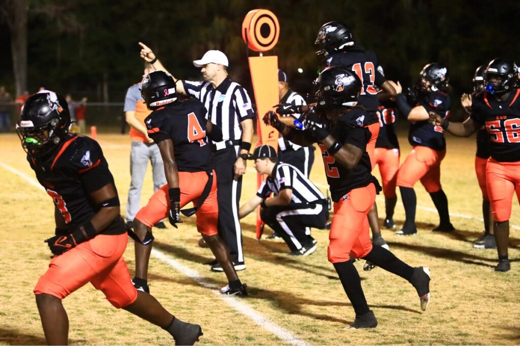 Hawthorne's defense celebrates after holding Williston on fourth down in the second quarter in the Rural-Region 4 Final. Photo by C.J. Gish 1 (1)