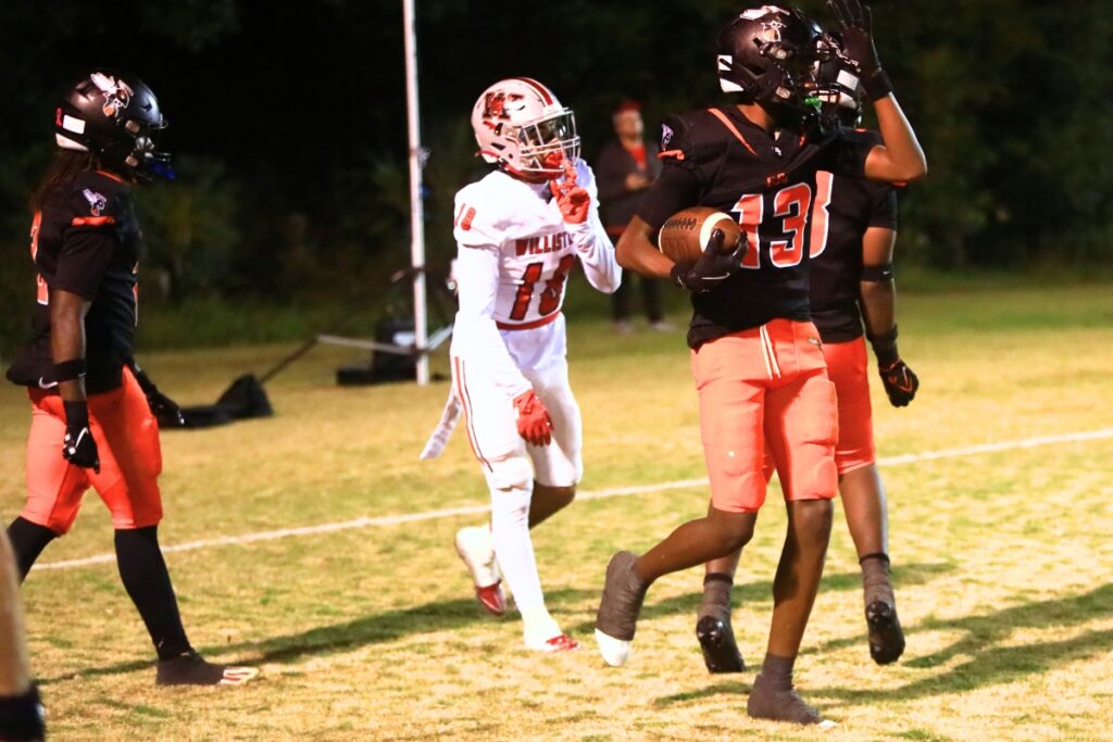 Hawthorne's Willie Sutton (13) celebrates after intercepting a Williston pass in the end zone late in the second quarter in the Rural-Region 4 Final. Photo by C.J. Gish
