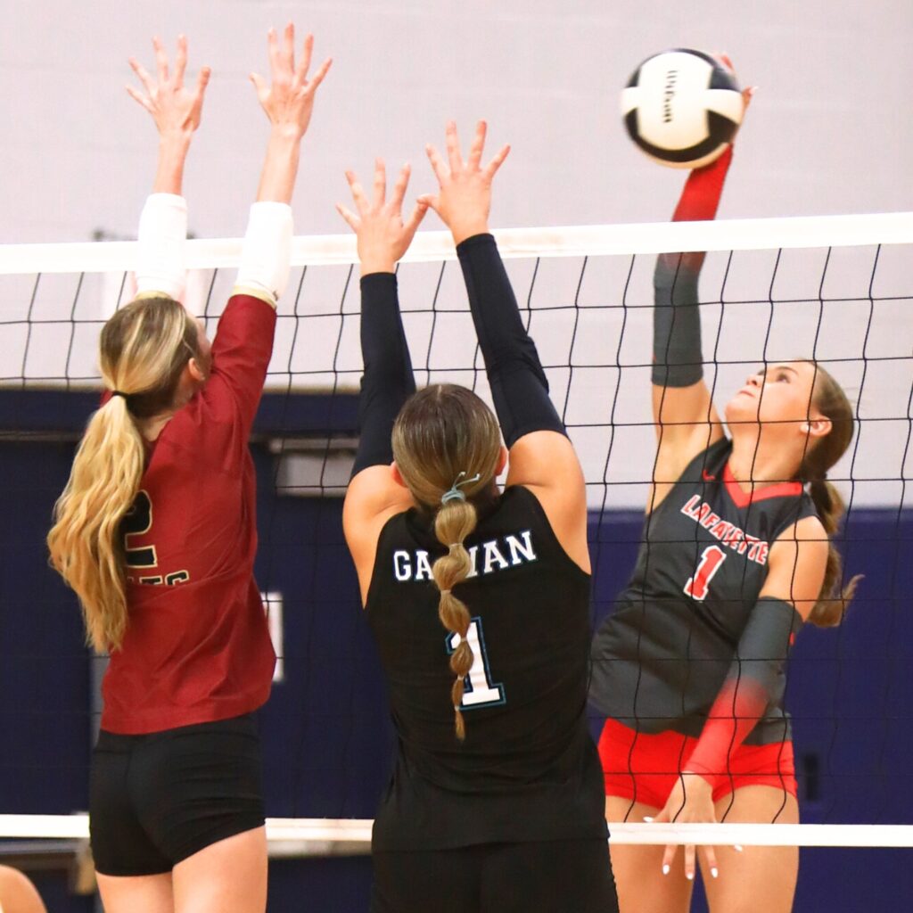 Lafayette's Brooke Lamb (1) goes for a hit against North Marion's Jacelyn Carson (2) and West Port's Joslynn Galvan (1) at The Prep Zone All-Star Showcase. Photo by C.J. Gish