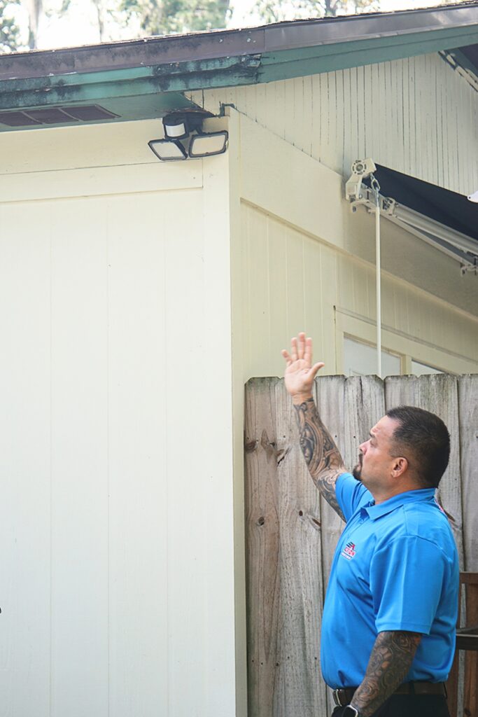 Lalo Castrillo, Action Roofing production manager, points out a section of the roof with water damage. Photo by Kirsten Rabin