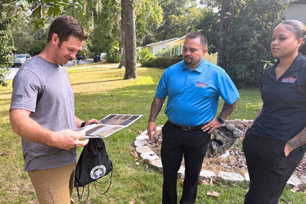 Mike S. (left) looks at shingle options from Action Roofing. Photo by Kirsten Rabin