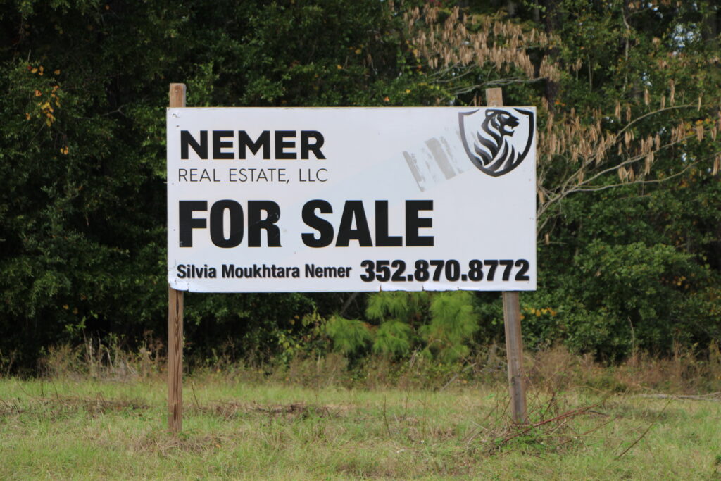 Nemer Real Estate, the company of Sayed Moukhtara's daughter, Silvia Moukhtara Nemer, advertises land for sale next to Mill Creek Sink. Photo by Lillian Hamman