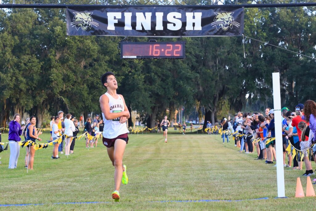 Oak Hall senior Andrew Eisner crosses the line first, with a nine-second lead over Bishop Kenny's Ethan Reid. Photo by Seth Johnson (1)