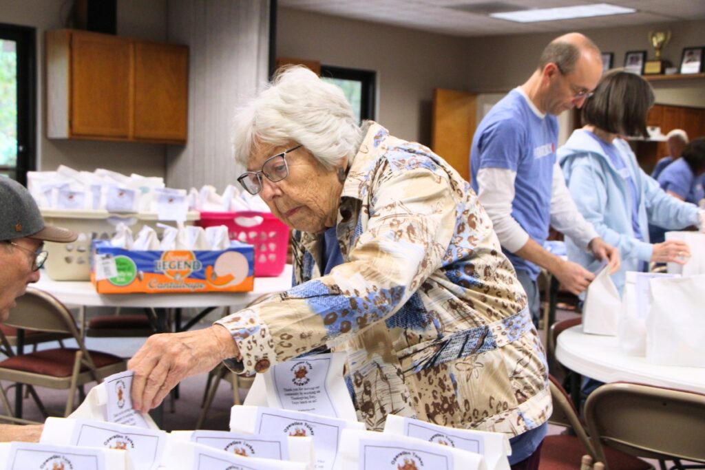 Ruth, one of Gethsemane Lutheran Church's oldest members, helps package meals for Operation Turkey Sandwich. Photo by Lillian Hamman
