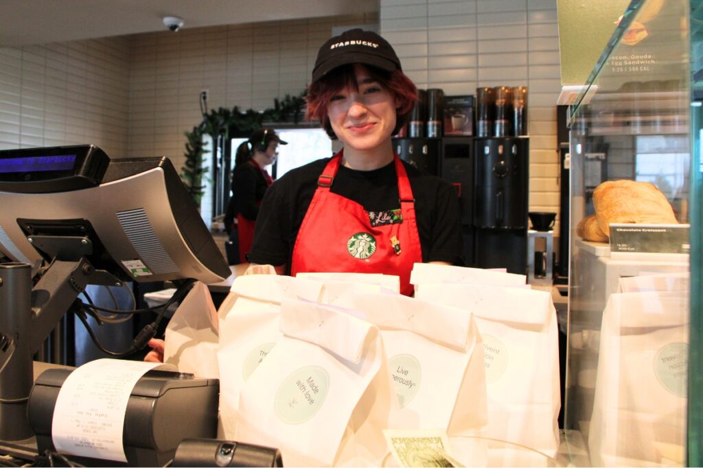 Starbucks employee Lila receives Operation Turkey Sandwich meals for the store's staff. Photo by Lillian Hamman