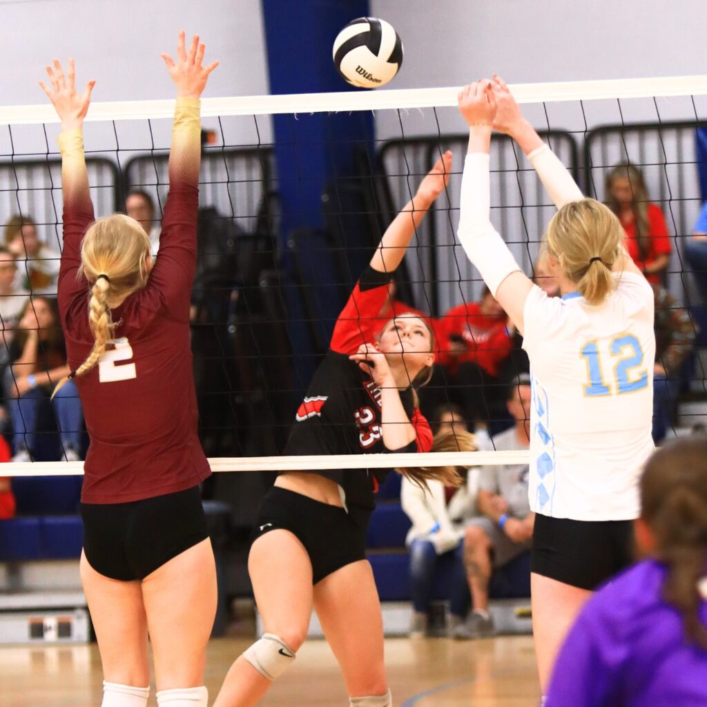The Rock's Alexis Rhoden (23) with a hit against Oak Hall's Lizzie Cannon (2) and Chiefland's Anna Jane Meeks (12) at The Prep Zone All-Star Showcase. Photo by C.J. Gish