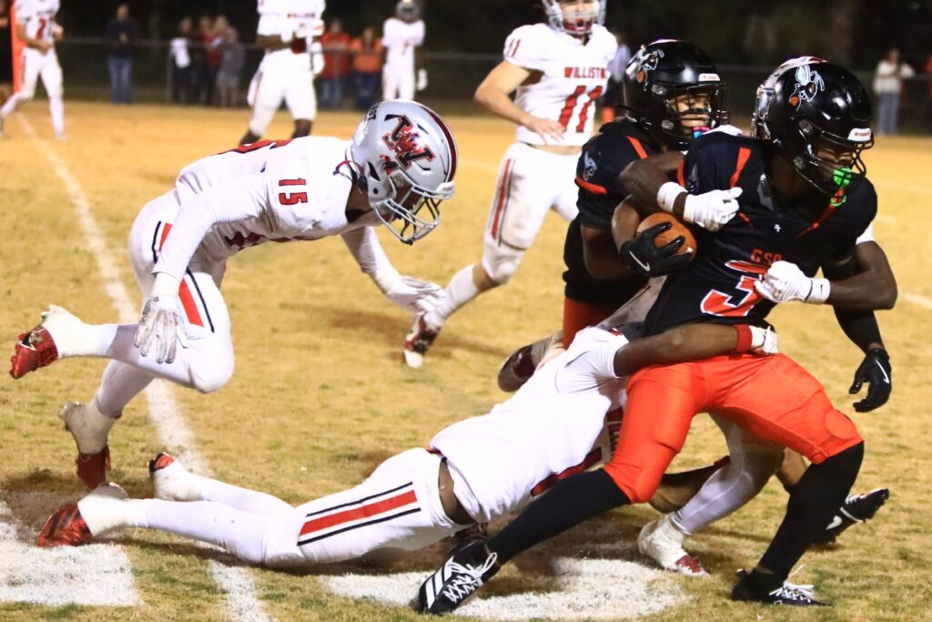 Williston defenders tackle Hawthorne's Dominick Harvey (4) in the Rural-Region 4 Final. Photo by C.J. Gish