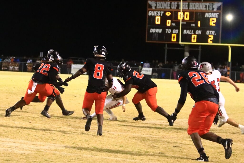 Williston quarterback John Jazikoff (14) gets sacked on the last play of the first half against Hawthorne in the Rural-Region 4 Final. Photo by C.J. Gish
