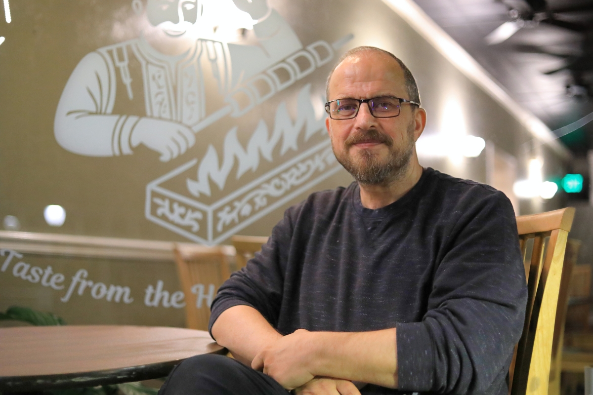 Mohammadali Asgari sits in front of his restaurant, Lor Kebab, in downtown Gainesville.