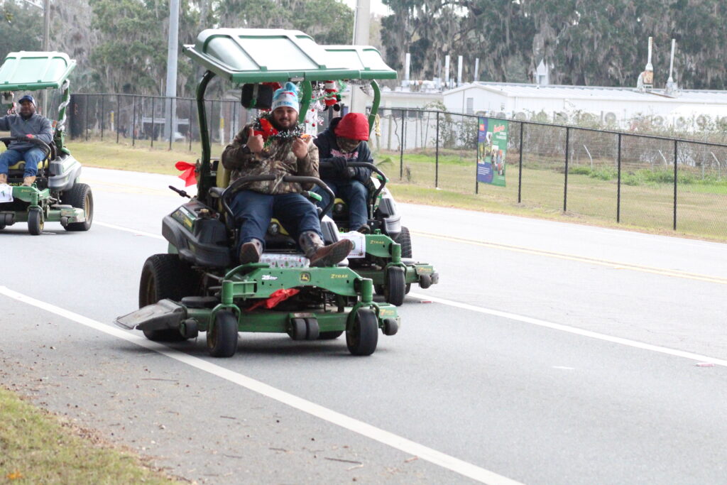 A UF Facilities Services employee gives a thumbs up during the Children's Christmas Parade (Photo by Nick Anschultz)