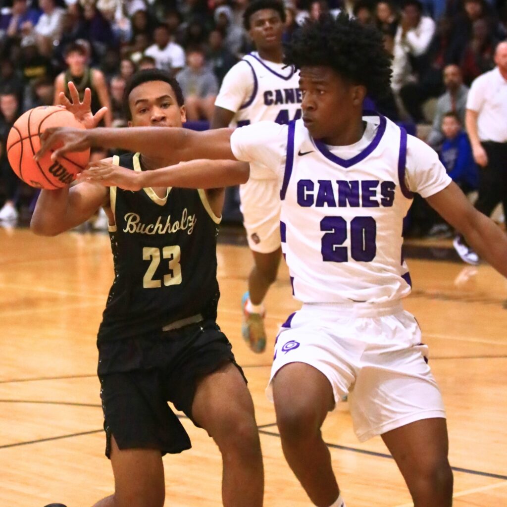 Buchholz's Collin Reynolds (23) gets fouled by Gainesville's Anthony Jenkins Jr. (20). Photo by C.J. Gish
