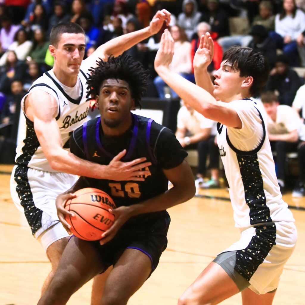 Buchholz's Gabe Williams (21) and Jacob Bromirski (0) close in on Columbia's Terrance Tolbert (20). Photo by C.J. Gish