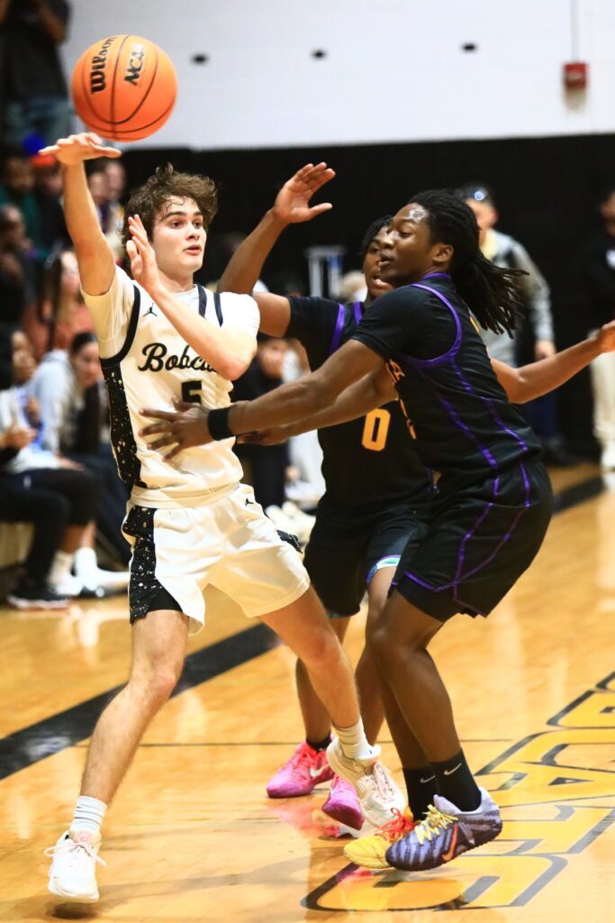 Buchholz's Lucas Bhatia (5) passes out of a trap by Columbia's Murkail Cray (0) and Kadrian Wilson (2). Photo by C.J. Gish