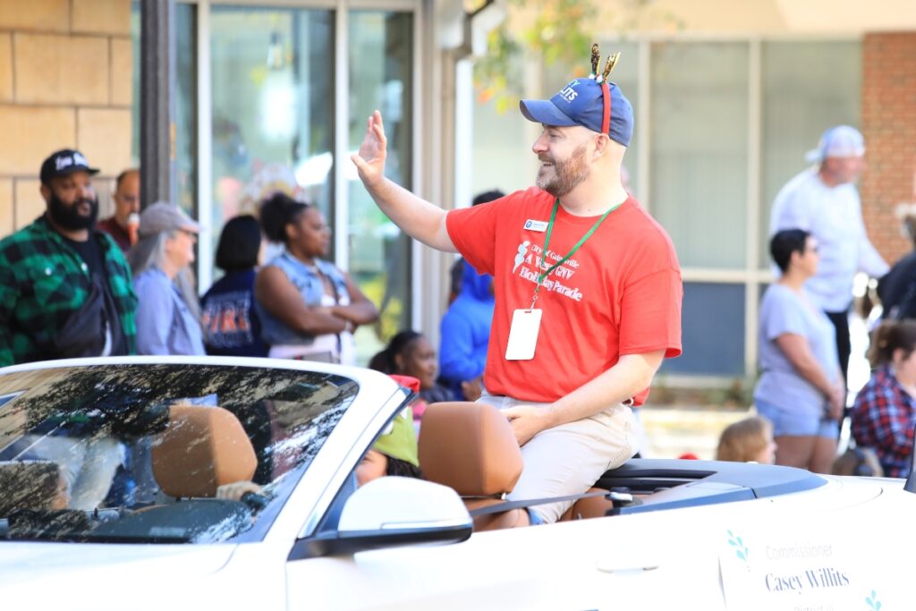 Commissioner Casey Willits rides in a convertible during A Very GNV Holiday Parade. Photo by Seth Johnson