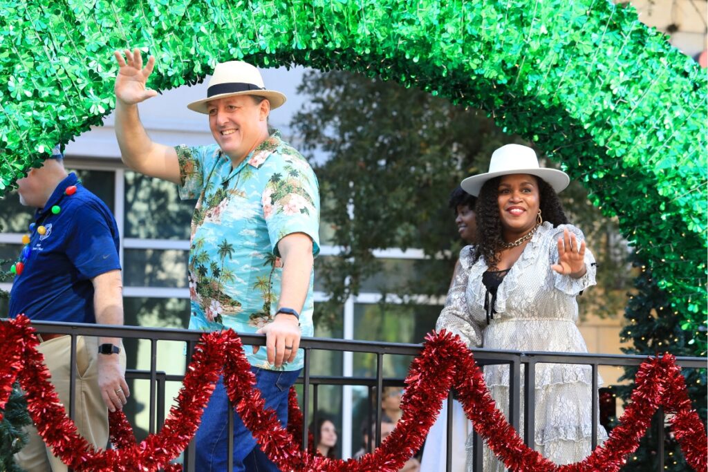 Commissioner James Ingle and Commissioner Desmon Duncan-Walker wave at attendees from the city's main float. Photo by Seth Johnson