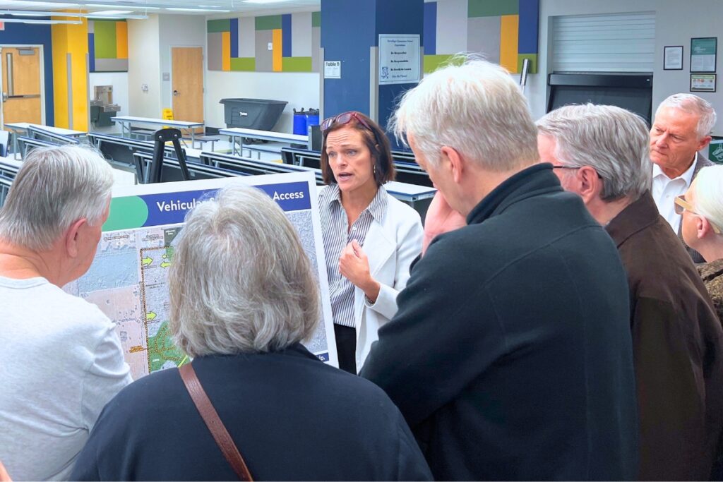 Community members listen as a project expert discusses a part of the plan related to the new UF golf course. Photo by Nick Anschultz