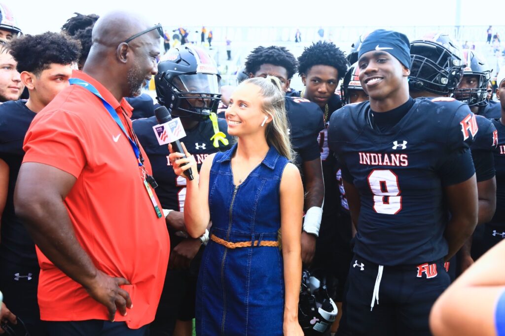 Fort White head coach Demetric Jackson (left) interviewed with son and quarterback Jayden Jackson (8) after the game against Port St. Joe in the Rural Florida Invitation Tournament.