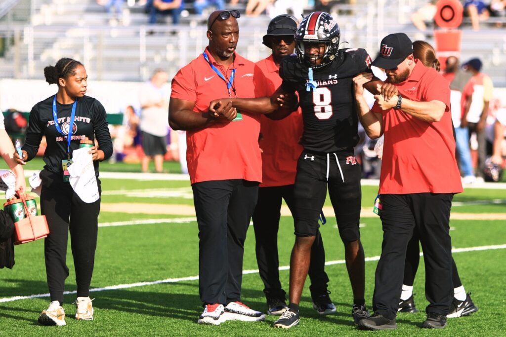 Fort White's Jayden Jackson (8) gets helped off the field after suffering leg crams in the fourth quarter against Port St. Joe in the Rural Florida Invitation Tournament Championship game.