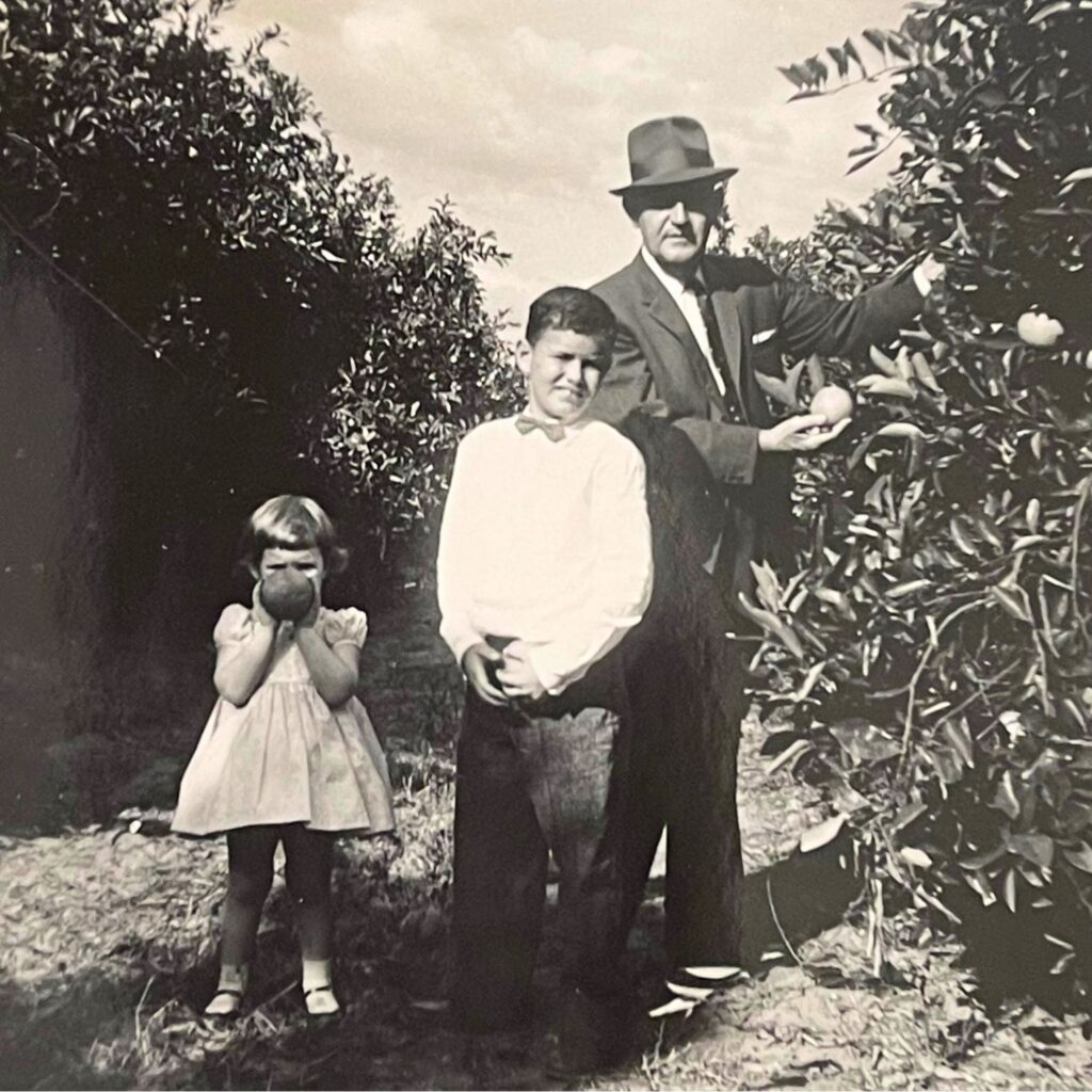 (From left) Diane Huff, her brother, Jim, and father, O.D. Buddy Huff Jr., in the family's orange grove on Orange Lake in McIntosh in 1959. Courtesy of Diane Huff
