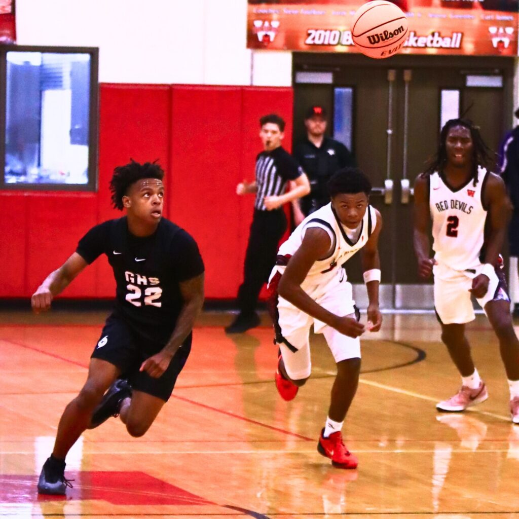 Gainesville's Davarion Howard (22) and Williston's Marcus Appling (1) hustle after a loose ball. Photo by C.J. Gish