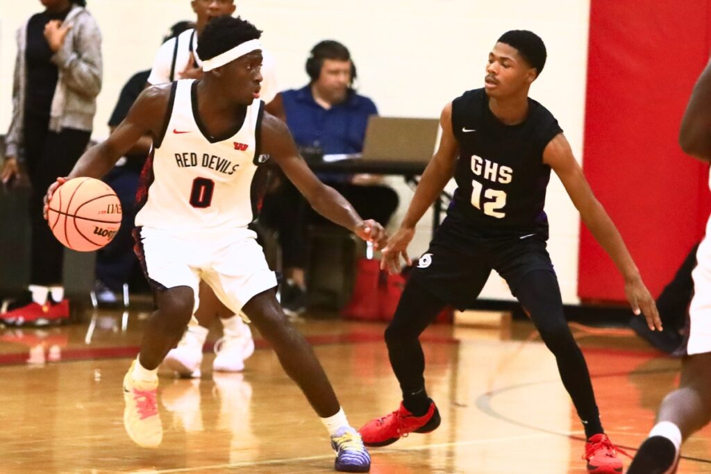 Gainesville's Jaishawn Sanford (12) defends Williston's Jac Edwards (0). Photo by C.J. Gish
