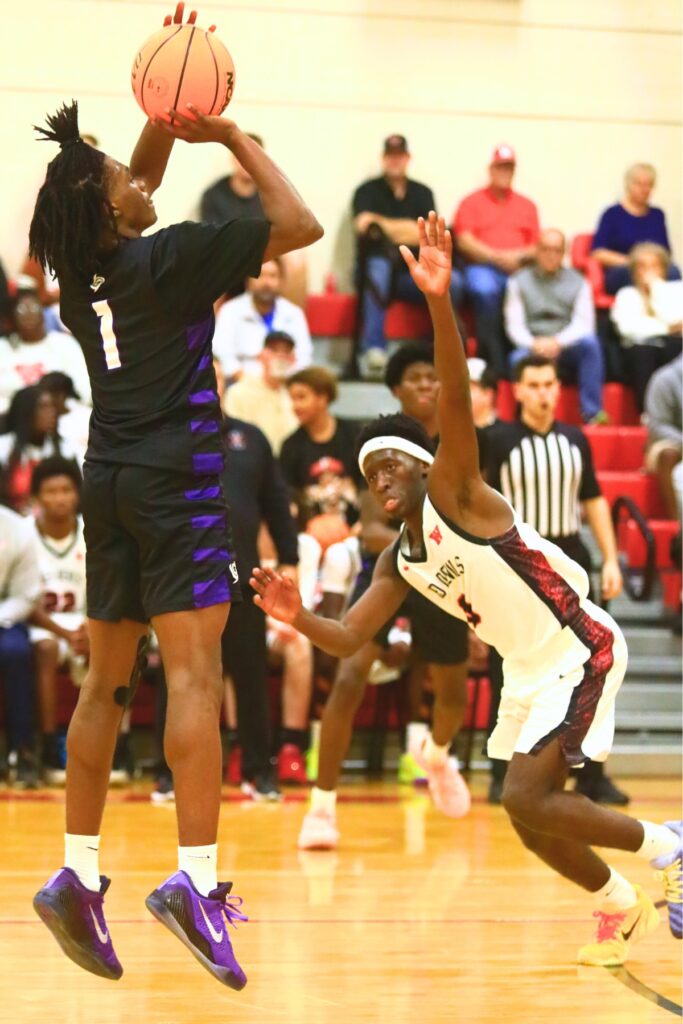 Gainesville's Willie Brooks (1) puts up a shot against Williston's Jac Edwards (0). Photo by C.J. Gish