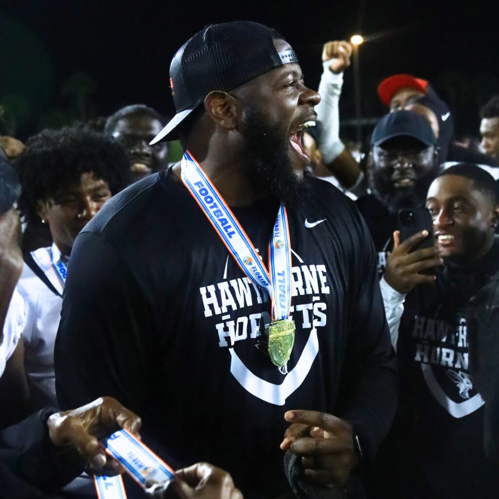 Hawthorne coach Cornelius Ingram does a dance after getting his medalion after the Hornets' win against Blountstown in the FHSAA Rural State Championship game. Photo by C.J. Gish
