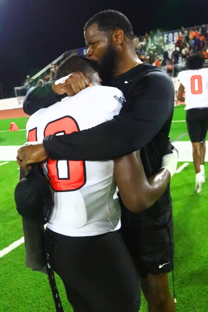 Hawthorne coach Cornelius Ingram embraces his son, Kyler Ingram (10), after the Hornets' win against Blountstown in the FHSAA Rural State Championship game. Photo by C.J. Gish